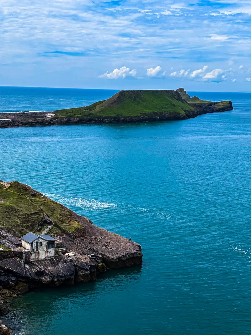 A hut on the rocks, Worm's Head beyond